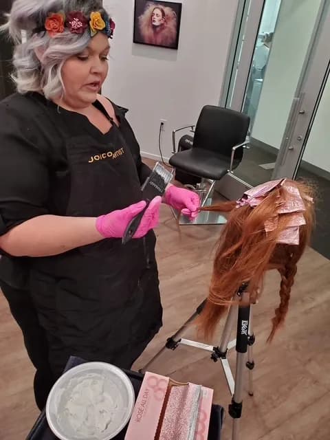 Karli applying color technique on a mannequin head